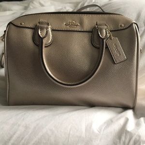 Coach gold handbag with adjustable carrying strap